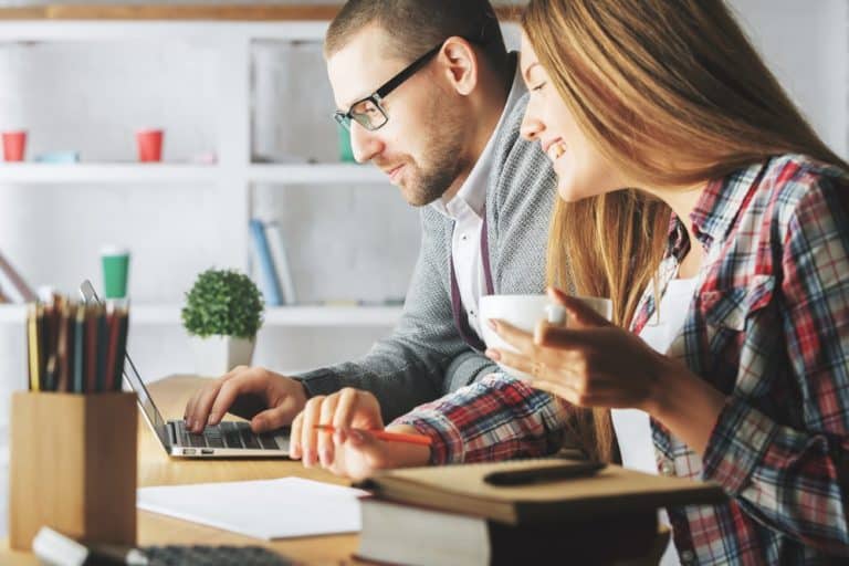 Business Loans Banner - Business owners calculating their loan repayments on a laptop