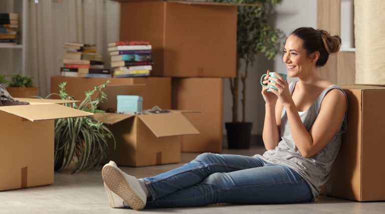 Woman sitting on the floor next to boxes