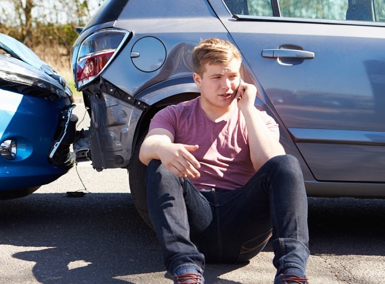 Man making phone call after car accident