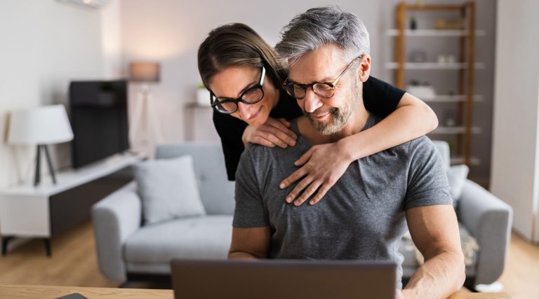 Couple looking at their laptop