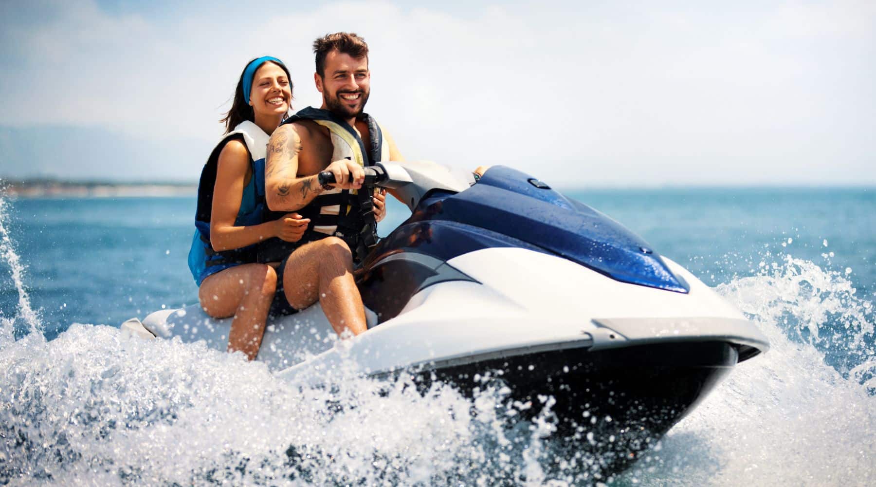 Man and woman riding a jet ski on the water