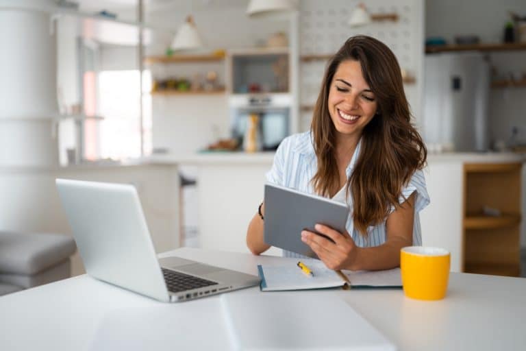 Woman at table using devices