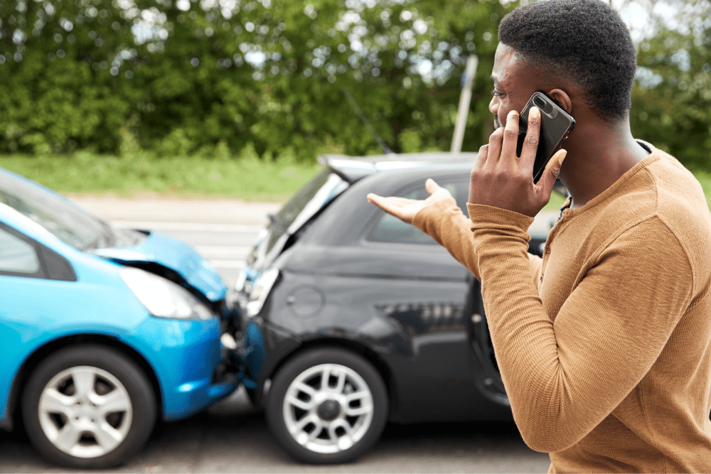 Man speaking on the phone after a car accident
